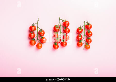 Cherry tomatoes on pink background Stock Photo