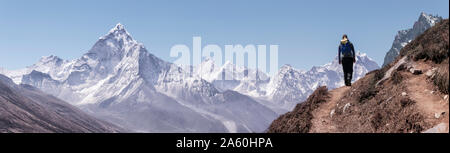 Young woman hiking in Sagarmatha National Park, Everest Base Camp trek, Nepal Stock Photo