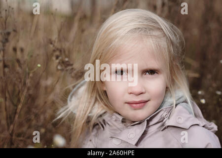 Portrait of blond little girl in autumn Stock Photo