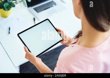 Close up of businesswoman using tablet in office Stock Photo