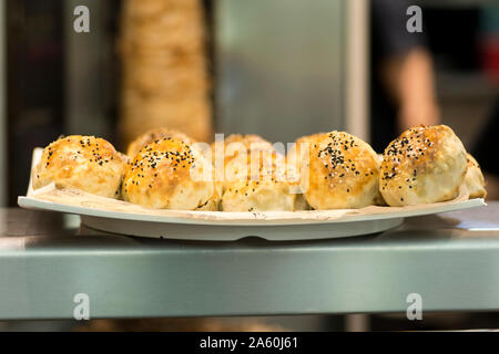 Bukharian (Uzbek) traditional pastries, stuffed with lamb meet and onion, with sesame and nigella Stock Photo