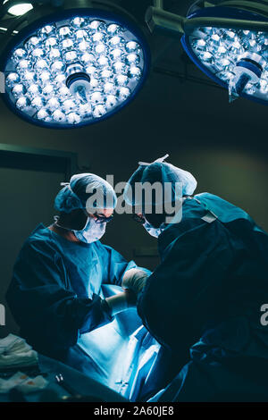 Surgeons during a surgery Stock Photo