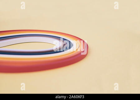 Close-up of multi colored quilling papers on beige background Stock Photo