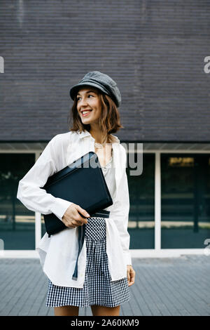 Pretty woman, carrying folder, commuting in the city Stock Photo