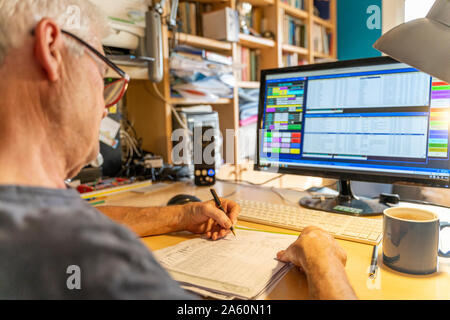 Senior man working in office, using computer Stock Photo