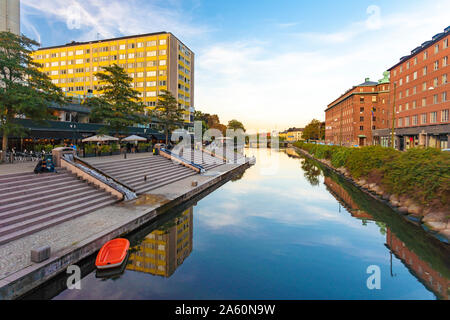 Canal amidst buildings against sky in Malmo, Sweden Stock Photo