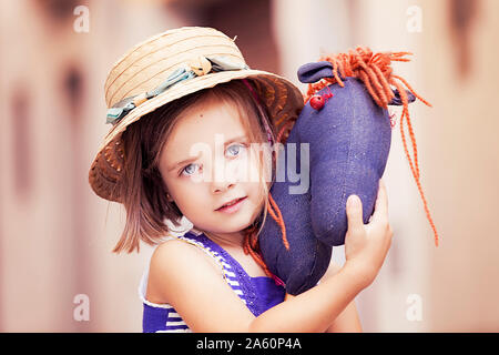 Portrait of little girl with hobby horse Stock Photo