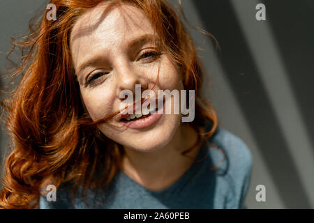 Portrait of smiling redheaded woman Stock Photo