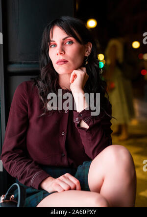 Portrait of a young woman in the city at night Stock Photo