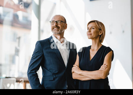 Portrait of confident businessman and woman Stock Photo