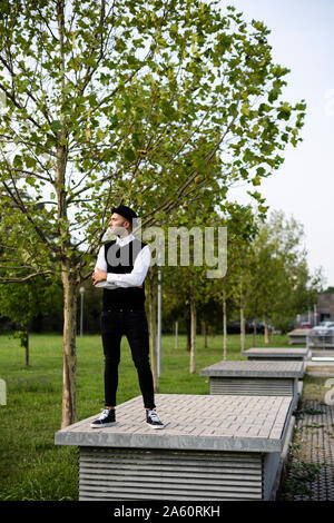 Young man dressed in black and white looking at distance Stock Photo