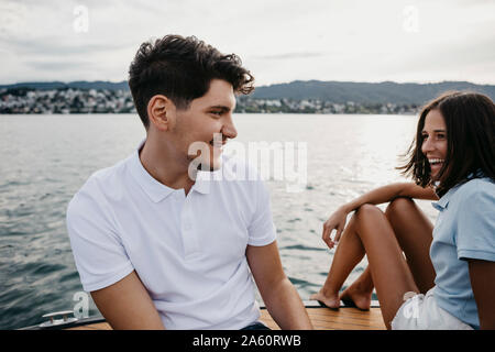 Happy young couple on a boat trip on a lake Stock Photo
