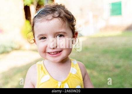 Portrait of a smiling little girl outdoors in summer Stock Photo