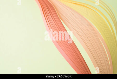 Close-up of colorful quilling papers on beige background Stock Photo