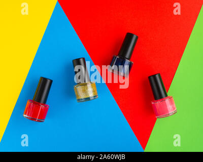 Nail varnish paint bottles on brightly coloured background Stock Photo