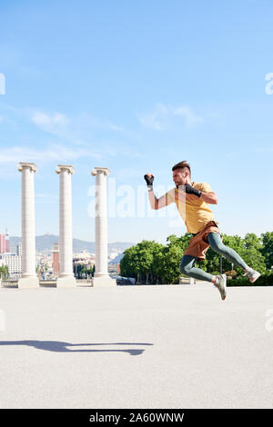 Man doing kickboxing exercise outdoors in the city Stock Photo