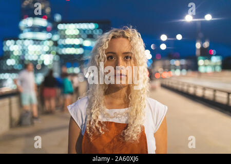 Young woman at dusk in London Stock Photo