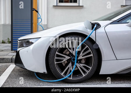 Electric car gettig charged at an charging station Stock Photo