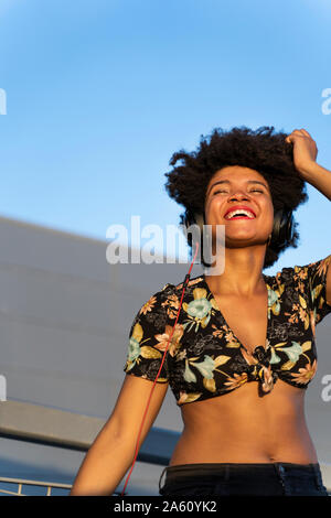 Female Afro-American with headphones listening music Stock Photo
