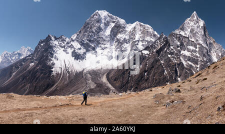 Young woman hiking in Sagarmatha National Park, Everest Base Camp trek, Nepal Stock Photo