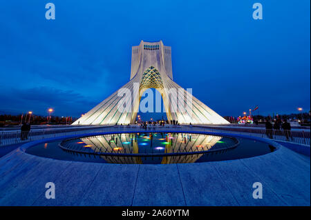 Azadi Tower (Freedom Monument) and cultural complex reflecting in a pond at sunset, Tehran, Islamic Republic of Iran, Middle East Stock Photo