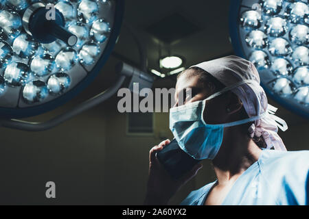 Nurse on the phone in operating room Stock Photo