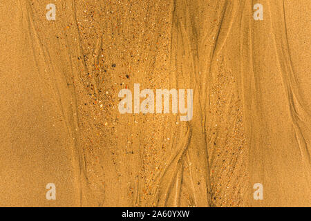 Close-up of sand with tidal ways and shells on the beach Stock Photo