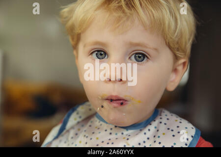 Portrait of blond little boy eating caviar and egg Stock Photo