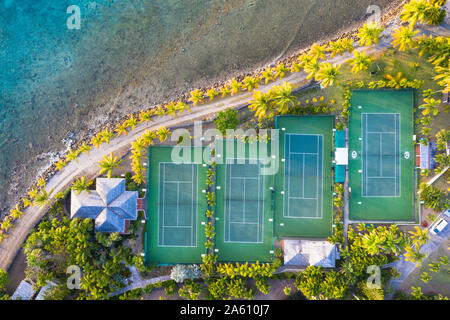 Tennis courts and palm trees in the luxury Curtain Bluff resort viewed from above, Old Road, Antigua, Leeward Islands, West Indies, Caribbean Stock Photo