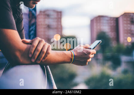 Man with pusera gay flag holding an smartphone Stock Photo