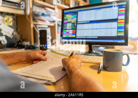 Senior man working in office, using computer Stock Photo