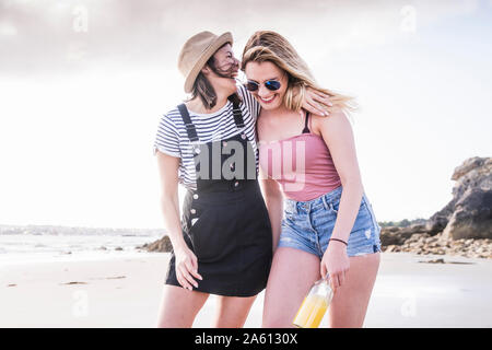 Two girlfriends having fun, walking on the beach Stock Photo