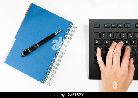 Female hands on the keyboard. Pen on blue notebook. Work and new idea concept Stock Photo