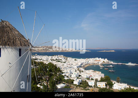 Windmill in foreground, Mykonos Town and Harbor, Mykonos Island, Cyclades Group, Greek Islands, Greece, Europe Stock Photo