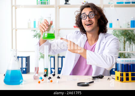 The funny male chemist working in the lab Stock Photo
