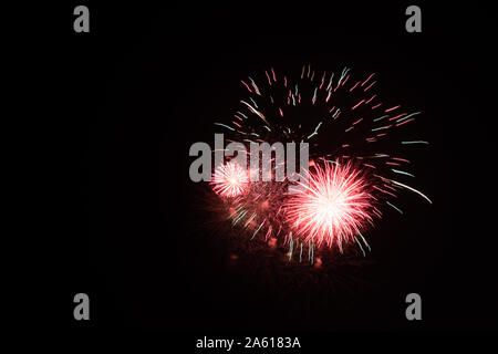 Fireworks photographed in the night sky with a long exposure and black background high quality image good for pc backgrounds and fine art prints.