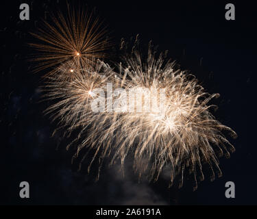 Fireworks photographed in the night sky with a long exposure and black background high quality image good for pc backgrounds and fine art prints. Stock Photo