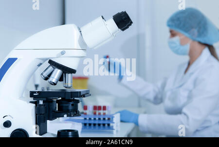 Woman scientist preparing samples with blood for researching Stock Photo