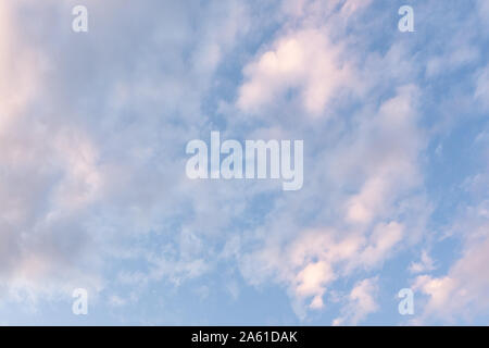many calm clouds in the light blue sky, background. Stock Photo