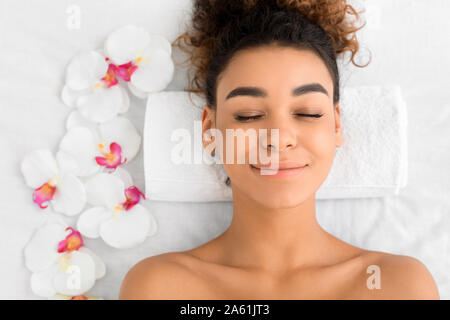 African-american woman getting face treatment at beauty salon Stock Photo