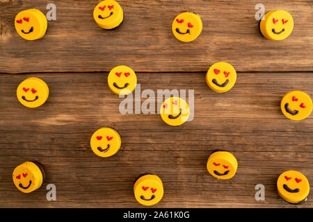 many delicious cupcakes on a wooden background with aline. Stock Photo