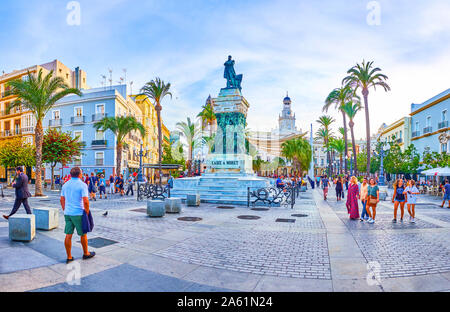 CADIZ, SPAIN - SEPTEMBER 19, 2019: Panoramic view on Plaza de San Juan de Dios with historical edifices, tourist cafes and restaurants and the monumen Stock Photo