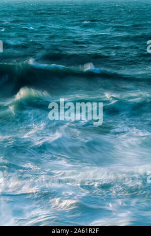 Long exposure of waves and the incoming tide Stock Photo
