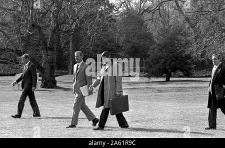 Washington DC., USA, January 28, 1984 President Ronald Reagan walks from the Oval Office across the White House South Lawn to board Marine One for a flight to Camp David in the Maryland Mountains. White House Chief of Staff James Baker III walks along side Reagan Stock Photo