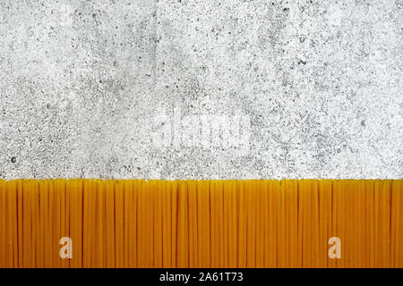 Types of uncooked pasta. Pasta spaghetti dry on a light concrete background. Shooting from above. Flat lay, top view, copy space. Stock Photo