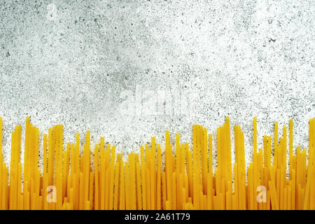 Types of uncooked pasta. Pasta spaghetti dry on a light concrete background. Shooting from above. Flat lay, top view, copy space. Stock Photo