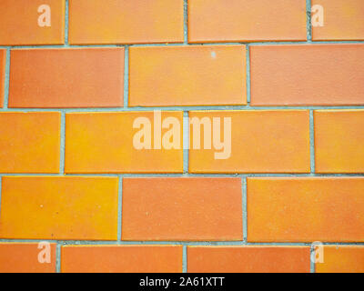 Orange wall tiles closeup. texture background. Orange Brick Wal Stock Photo