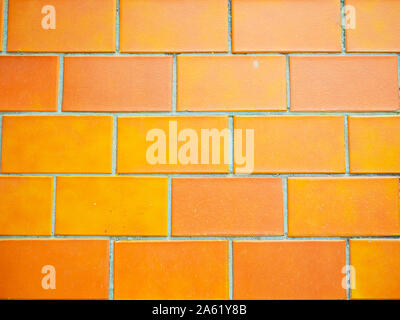 Orange wall tiles closeup. texture background. Orange Brick Wal Stock Photo