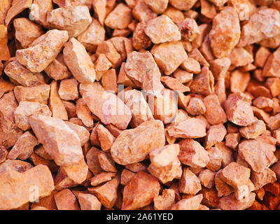 orange little pebbles. Background composed of small orange pebbles. With many possible uses. Texture composed of tiny pebbles in orange shade  Stock Photo