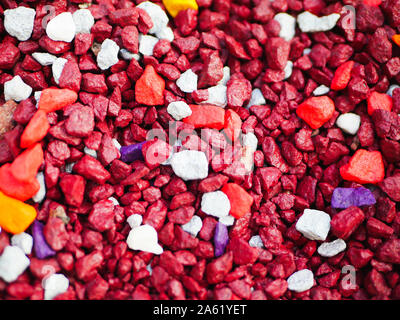 red little pebbles. The background consists of small red pebbles. With many possible uses. The texture is composed of tiny red pebbles. Stock Photo